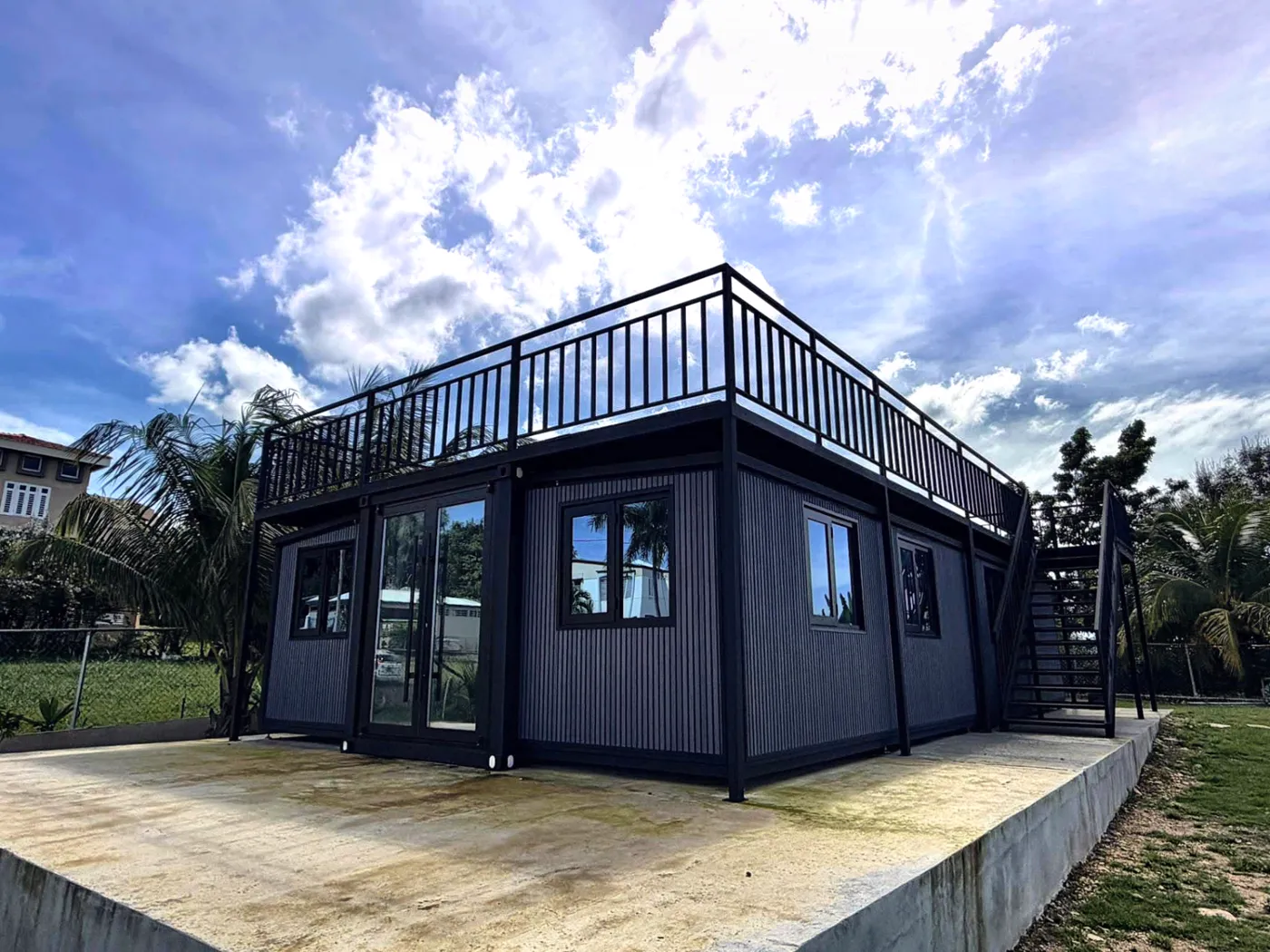The Escape, a dark-clad THiNQ unit with a roof terrace and external stair